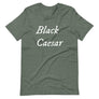 Grey unisex t-shirt with "Black Caesar" written in White, on two horizontal lines across the front. Black Caesar (died 1718) was a legendary 18th-century African pirate. The legends say that for nearly a decade, he raided shipping from the Florida Keys and later served as one of Captain Blackbeard's, a.k.a. Edward Teach's, crewmen aboard the Queen Anne's Revenge