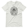 Light Grey short sleeve t-shirt with centered skull and cross bones, with small additional artistic accents, surrounded in a circular pattern with "Fortune Favors the Brave". All lettering and imagining is in Black.