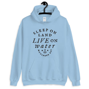 Powder Blue unisex hoodie with wording "Sleep on Land, Live on Water" written in black artistic lettering on front. Underneath this is very small semi circle stating "Mutineer Bay" centered with small anchor.