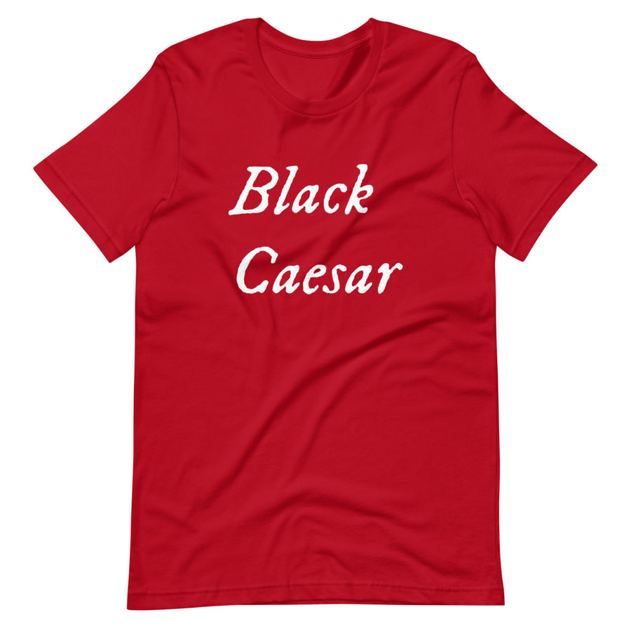 Redunisex t-shirt with "Black Caesar" written in White, on two horizontal lines across the front. Black Caesar (died 1718) was a legendary 18th-century African pirate. The legends say that for nearly a decade, he raided shipping from the Florida Keys and later served as one of Captain Blackbeard's, a.k.a. Edward Teach's, crewmen aboard the Queen Anne's Revenge