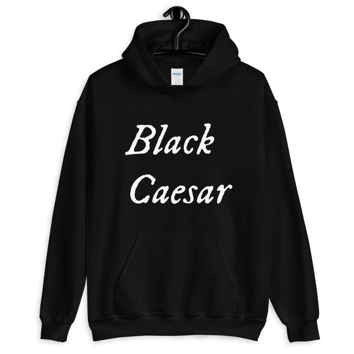 Black unisex hoodie with "Black Caesar" written horizontally, on two lines, on the front and back in white lettering. Black Caesar (died 1718) was a legendary 18th-century African pirate. The legends say that for nearly a decade, he raided shipping from the Florida Keys and later served as one of Captain Blackbeard's, a.k.a. Edward Teach's, crewmen aboard the Queen Anne's Revenge