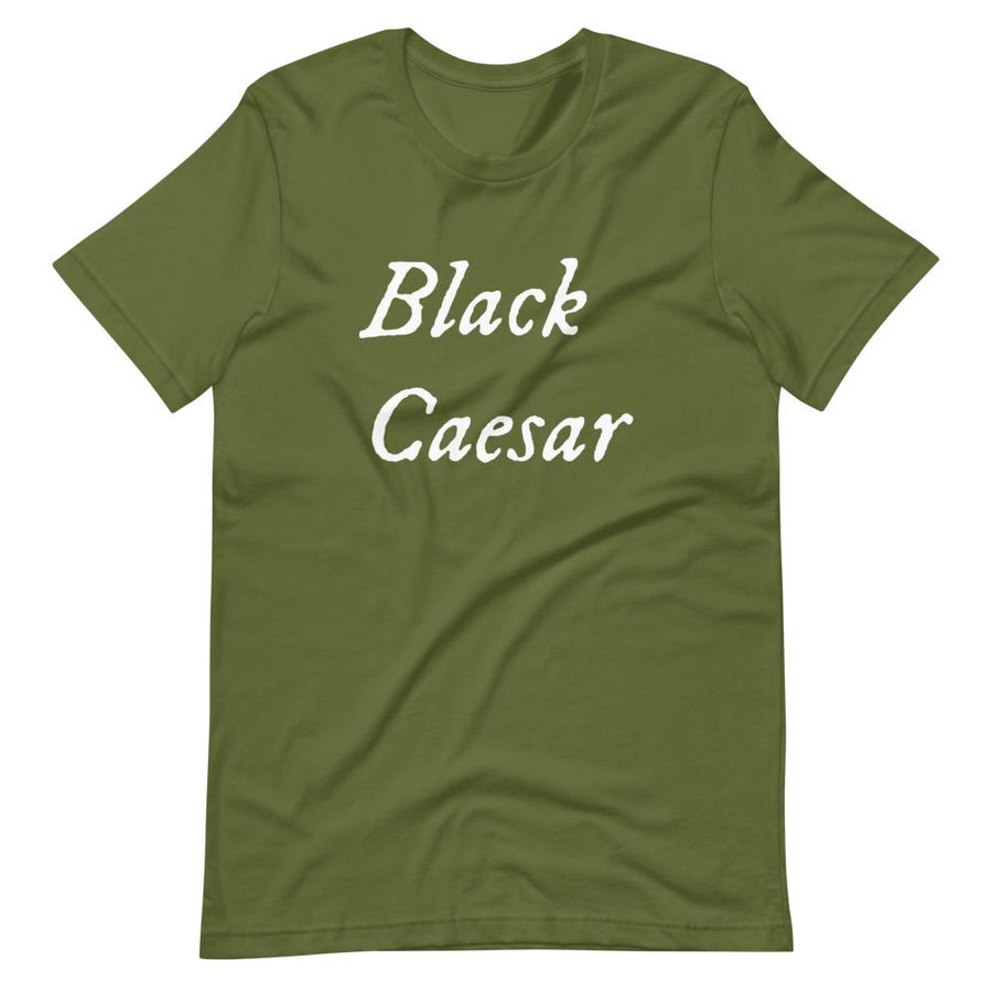 Mustard green unisex t-shirt with "Black Caesar" written in White, on two horizontal lines across the front. Black Caesar (died 1718) was a legendary 18th-century African pirate. The legends say that for nearly a decade, he raided shipping from the Florida Keys and later served as one of Captain Blackbeard's, a.k.a. Edward Teach's, crewmen aboard the Queen Anne's Revenge