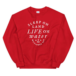 Bright Red unisex sweatshirt with wording in white, "Sleep on Land, Live on Water" written in black artistic lettering on front. Underneath this is very small semi circle stating "Mutineer Bay" centered with small anchor. All lettering and images are in white.